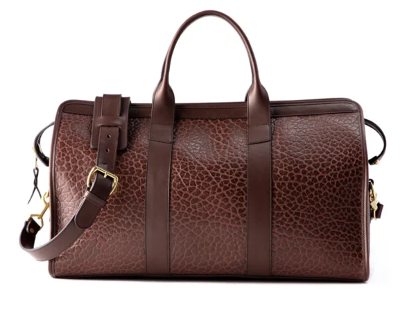 Signature 20-inch Legacy Leather Travel Duffle Bag with rolled handles, detachable shoulder strap, and brass hardware.